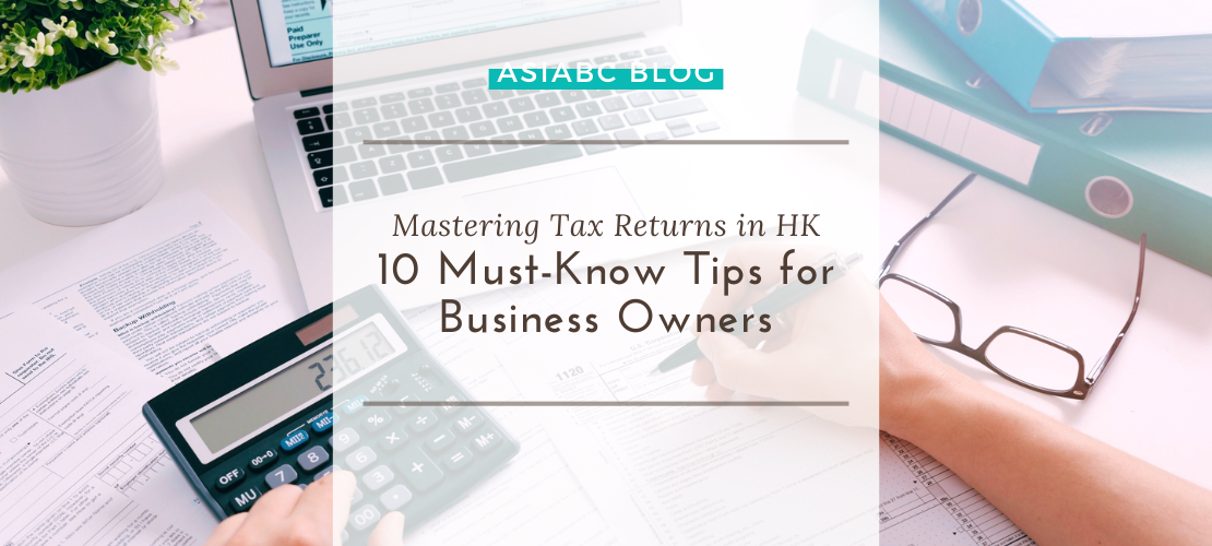 Work desk with a calculator, tax forms, & a laptop, highlighting AsiaBC's tips for mastering tax returns for HK entrepreneurs.