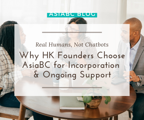 Entrepreneurs meeting with consultants at table with laptop & coffee mugs, discussing HK company setup & ongoing support.